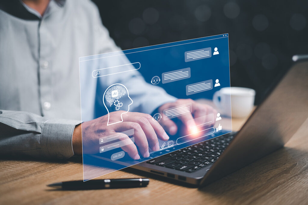 Man typing on laptop that is showing conversation bubbles